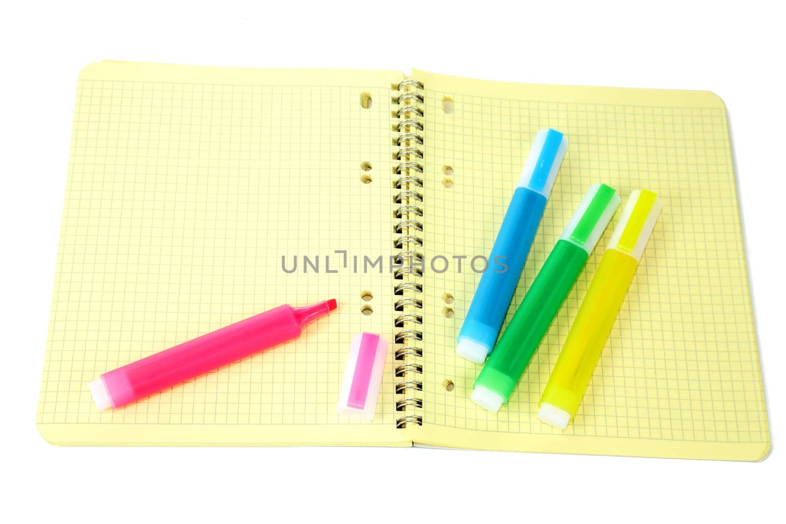 Markers and writing-book with a spiral on  white background