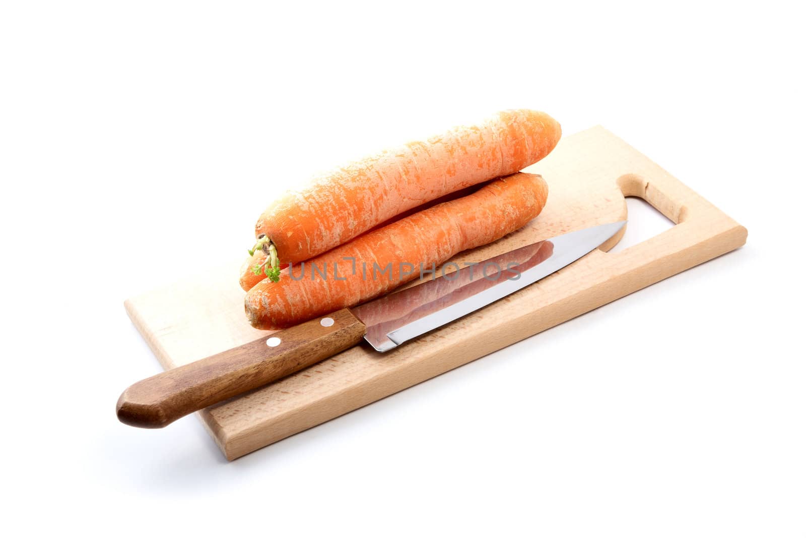 Carrots  and  knife on a chopping board  white background