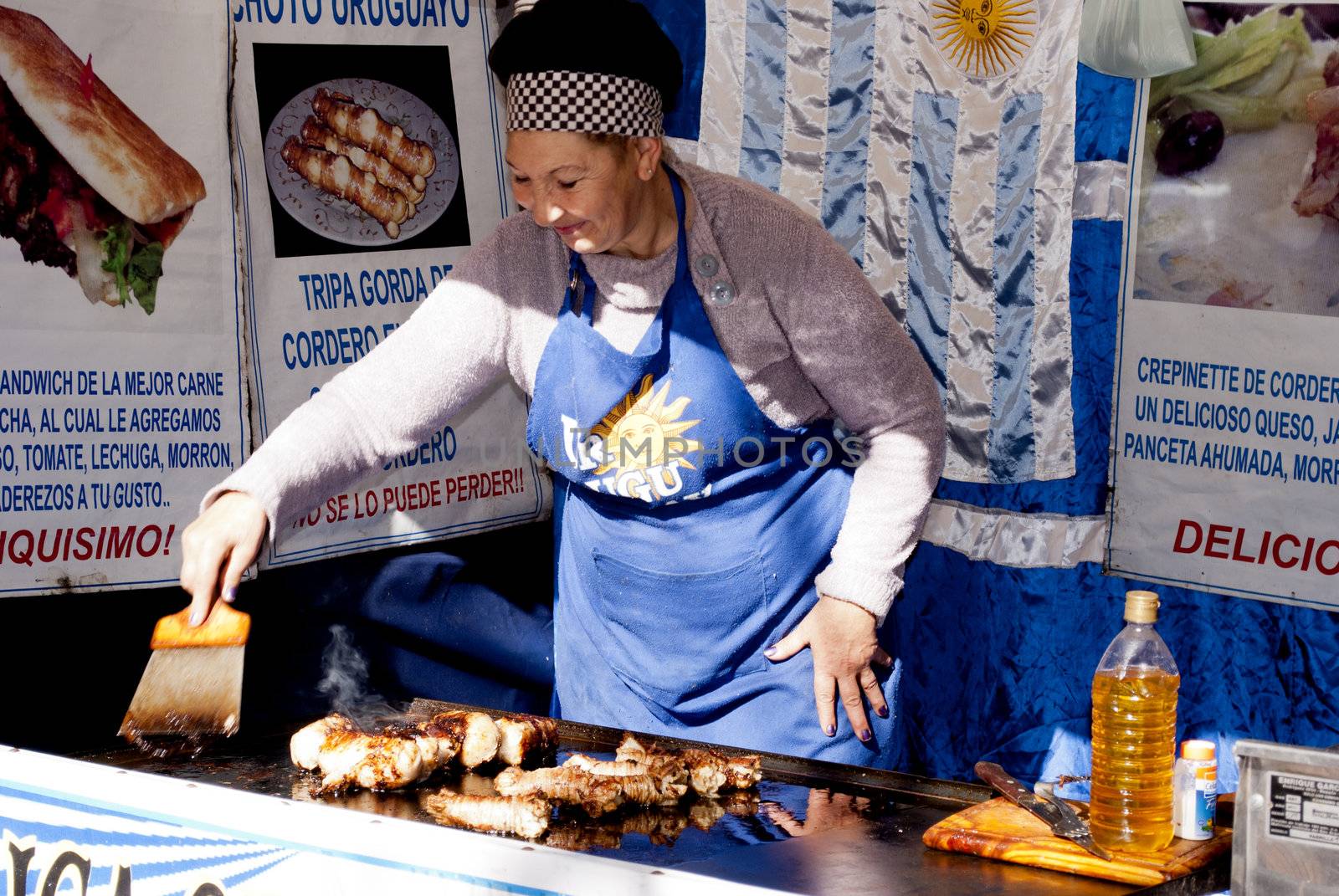 Buenos Aires, Argentina - May 12, 2012, Woman cooking typical food in Uruguay's booth at the fair organized nations in the city of San Fernando, Province of Buenos Aires