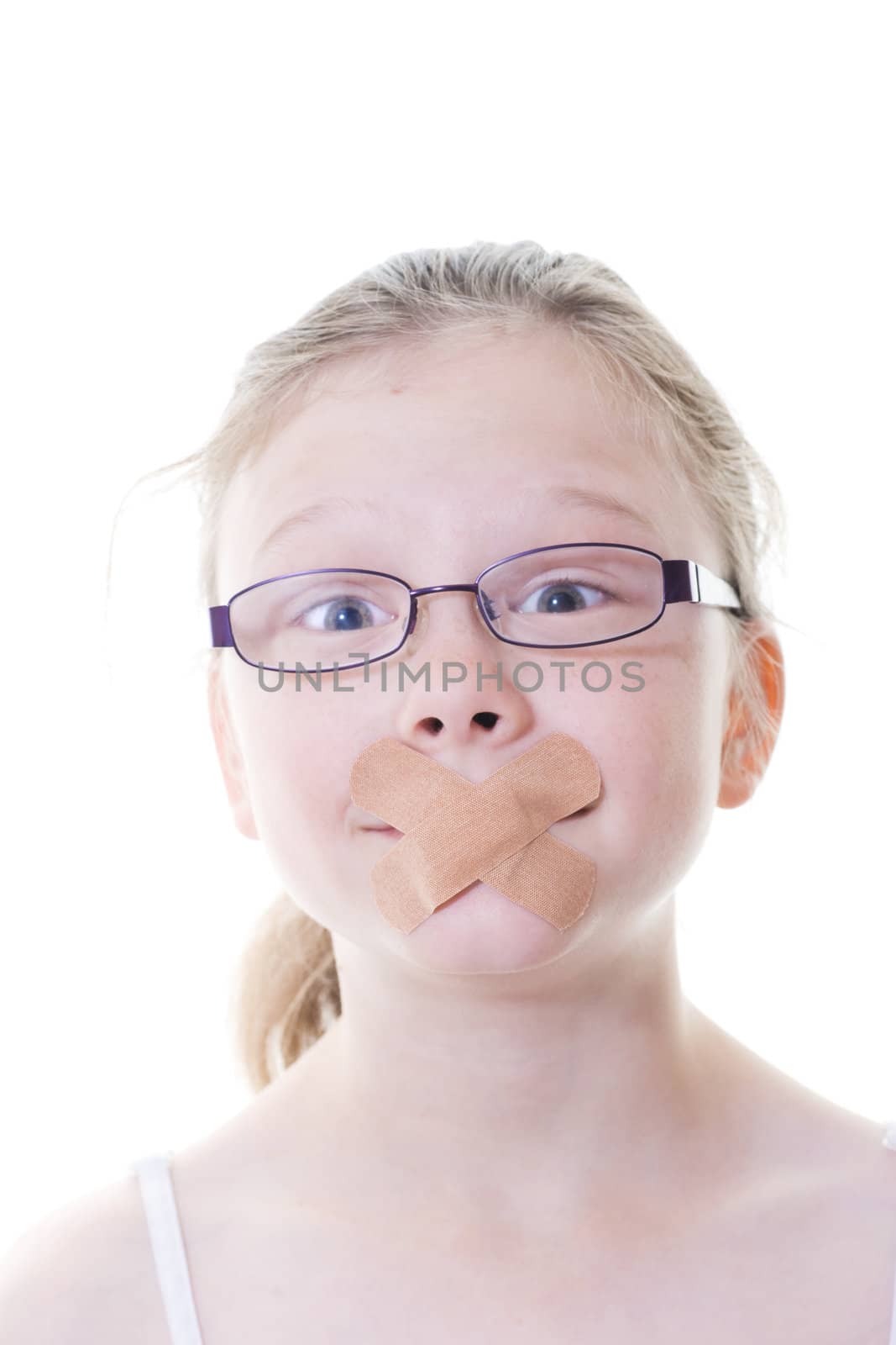 preteen girl with sticking plaster across her mouth