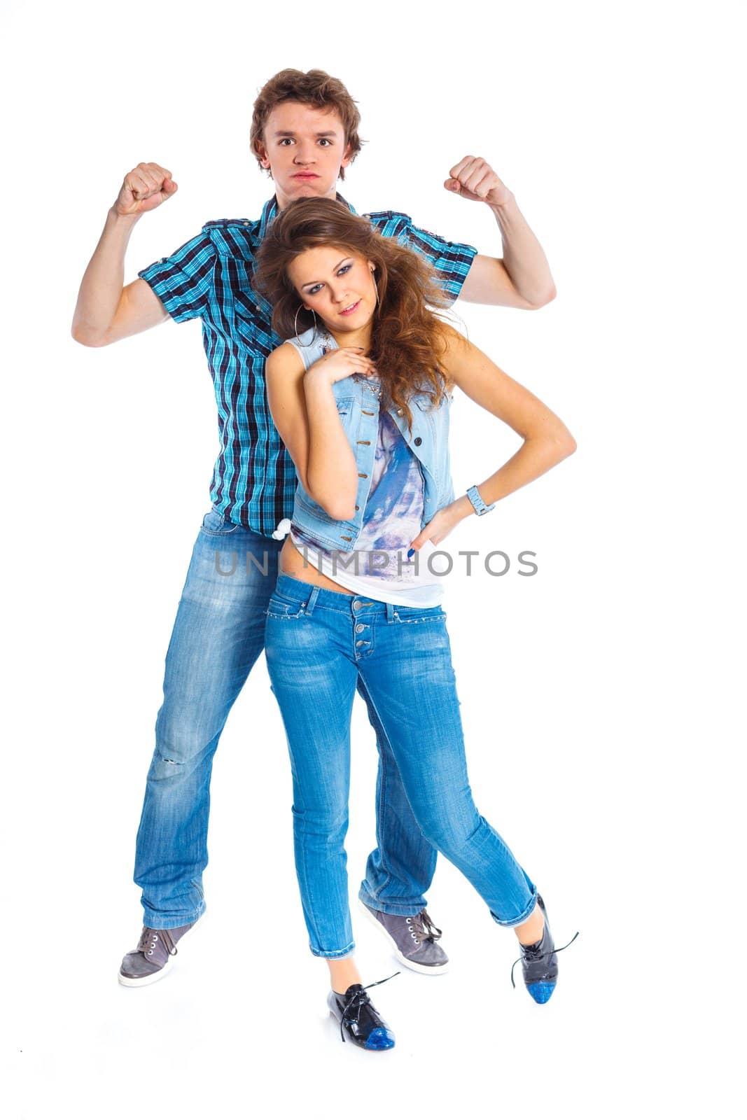 Smiling teenager boy indulge his pretty girlfriend. Isolated on white background.