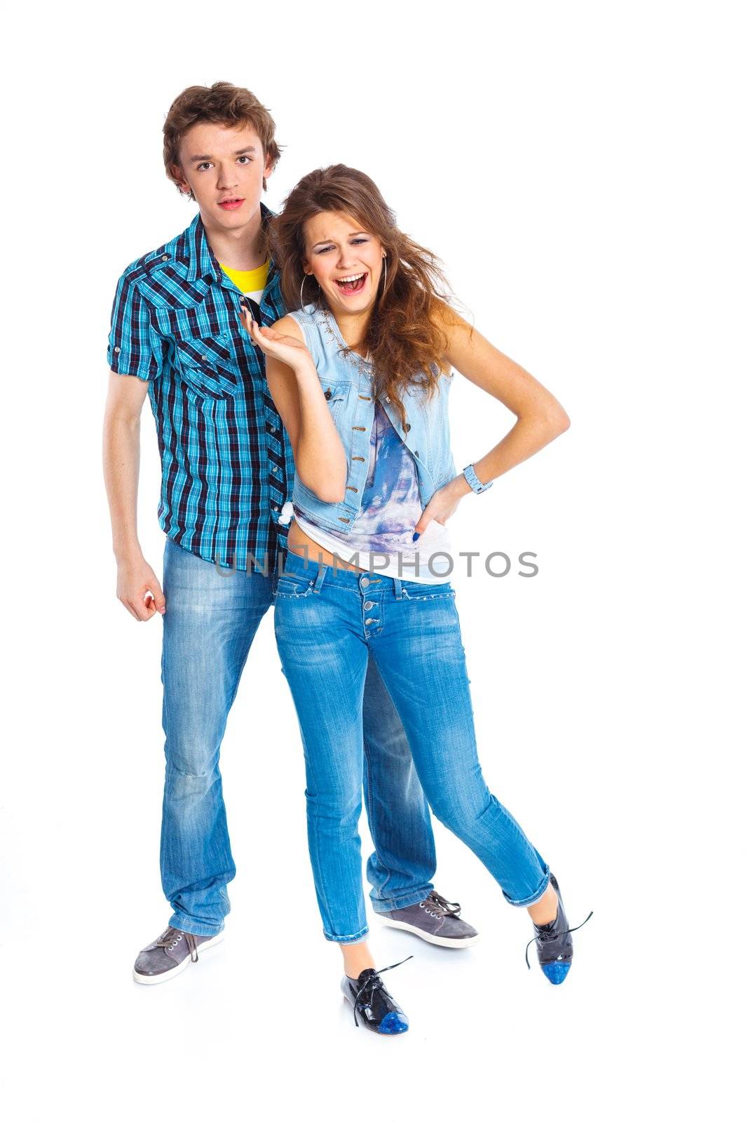 Smiling teenager boy indulge his pretty girlfriend. Isolated on white background.