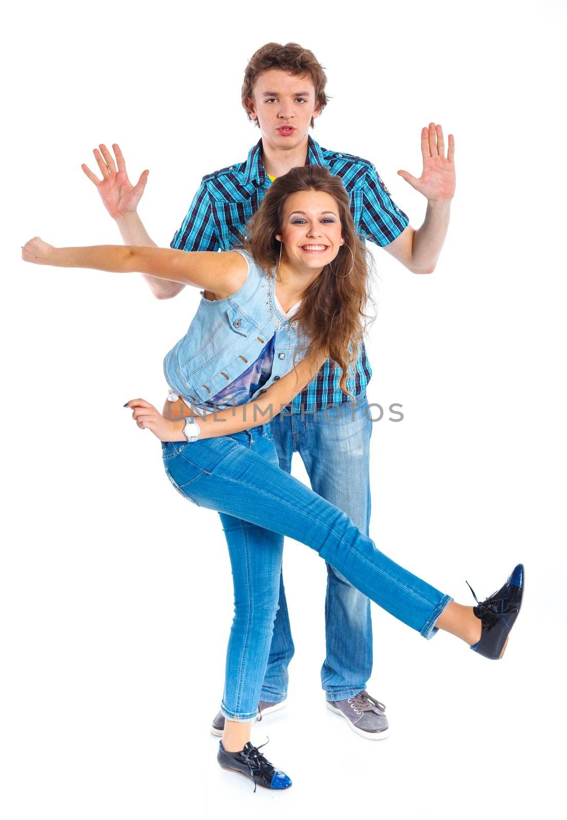 Smiling teenager boy indulge his pretty girlfriend. Isolated on white background.