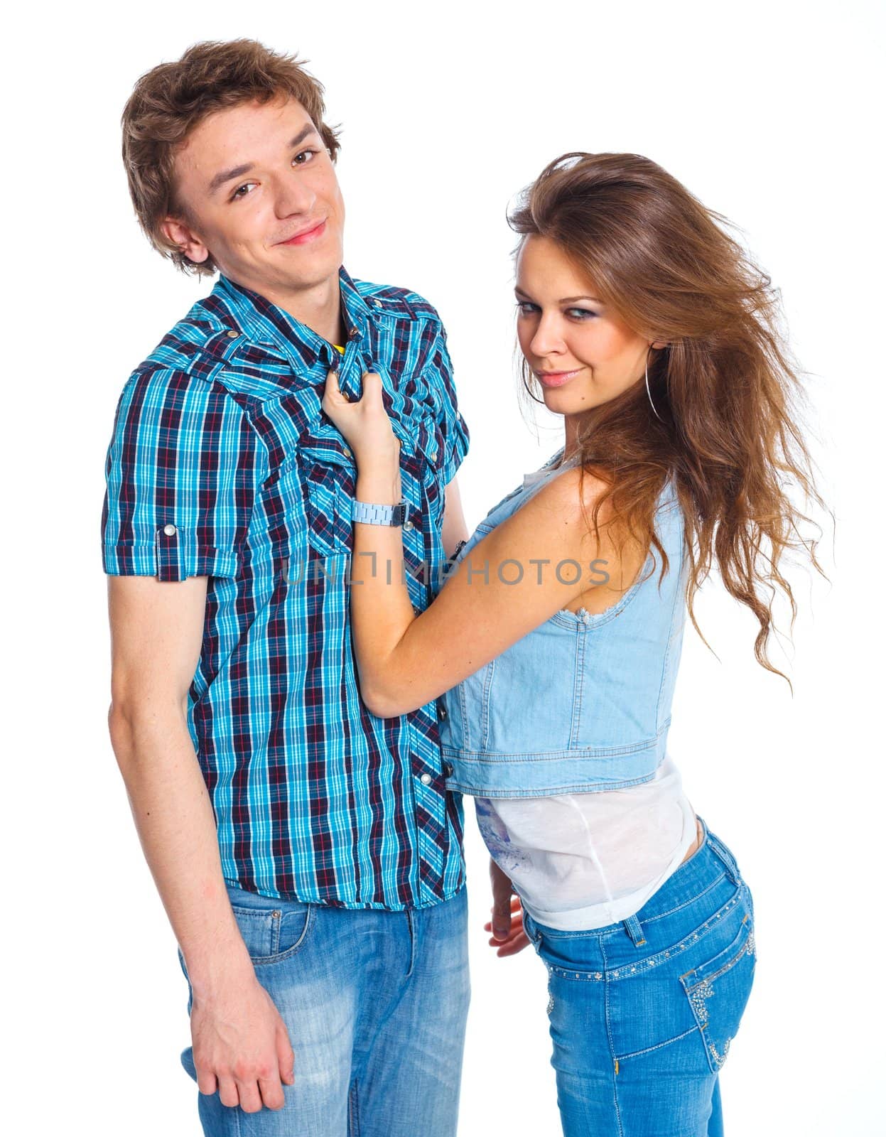 Smiling teenager boy indulge his pretty girlfriend. Isolated on white background.