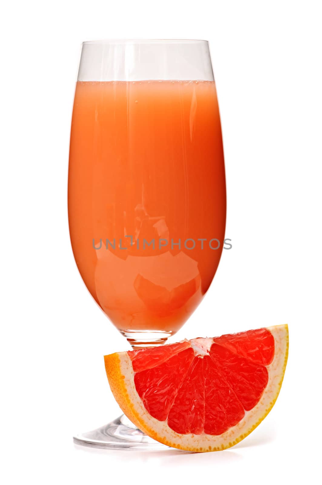Grapefruit juice in glass by elenathewise