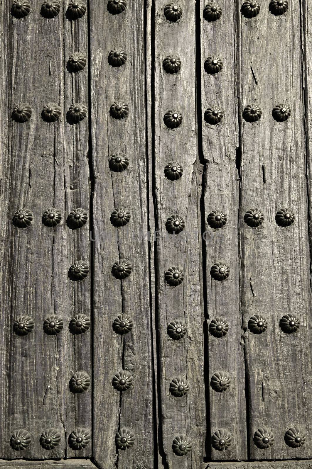 Background of old wooden door with metal studs