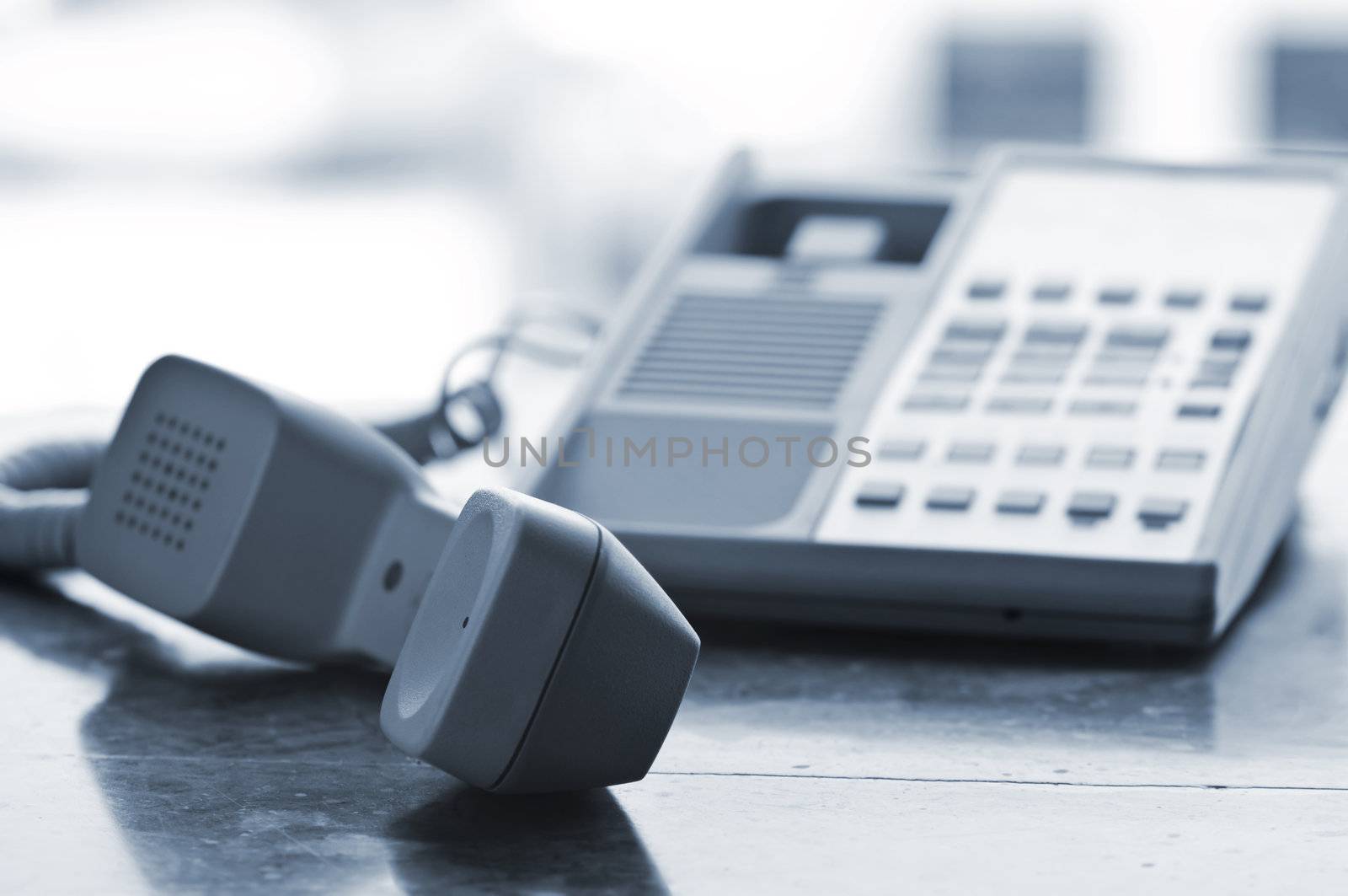 Telephone handset off the hook on desk