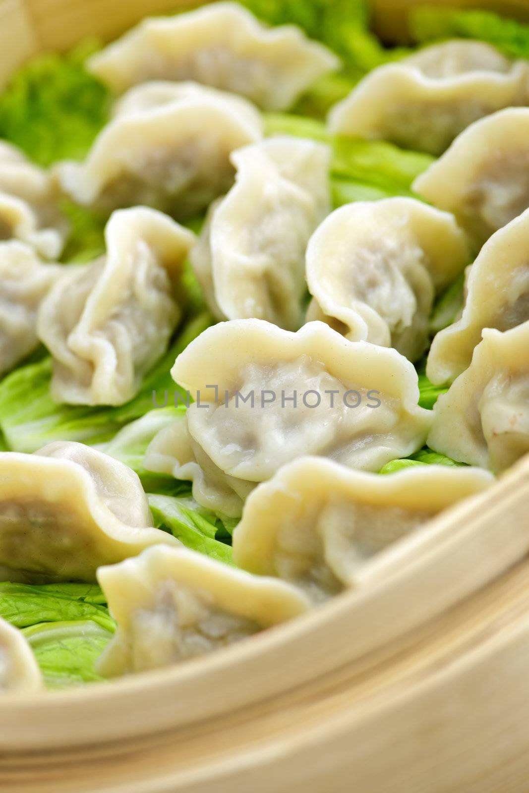 Bamboo steamer with dumplings by elenathewise
