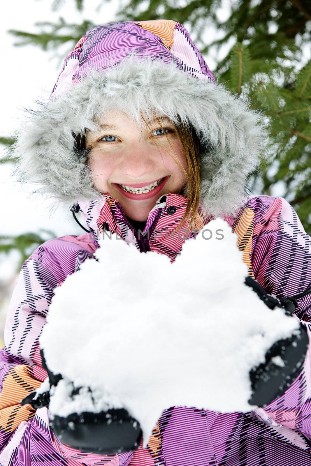 Happy winter girl holding snow by elenathewise