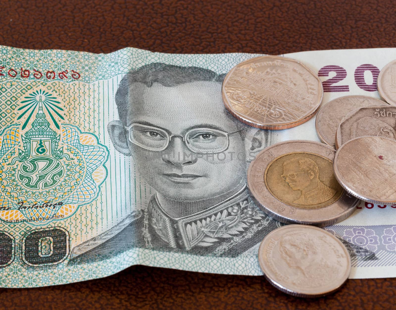 Twenty baht note from Thailand with miscellaneous coins