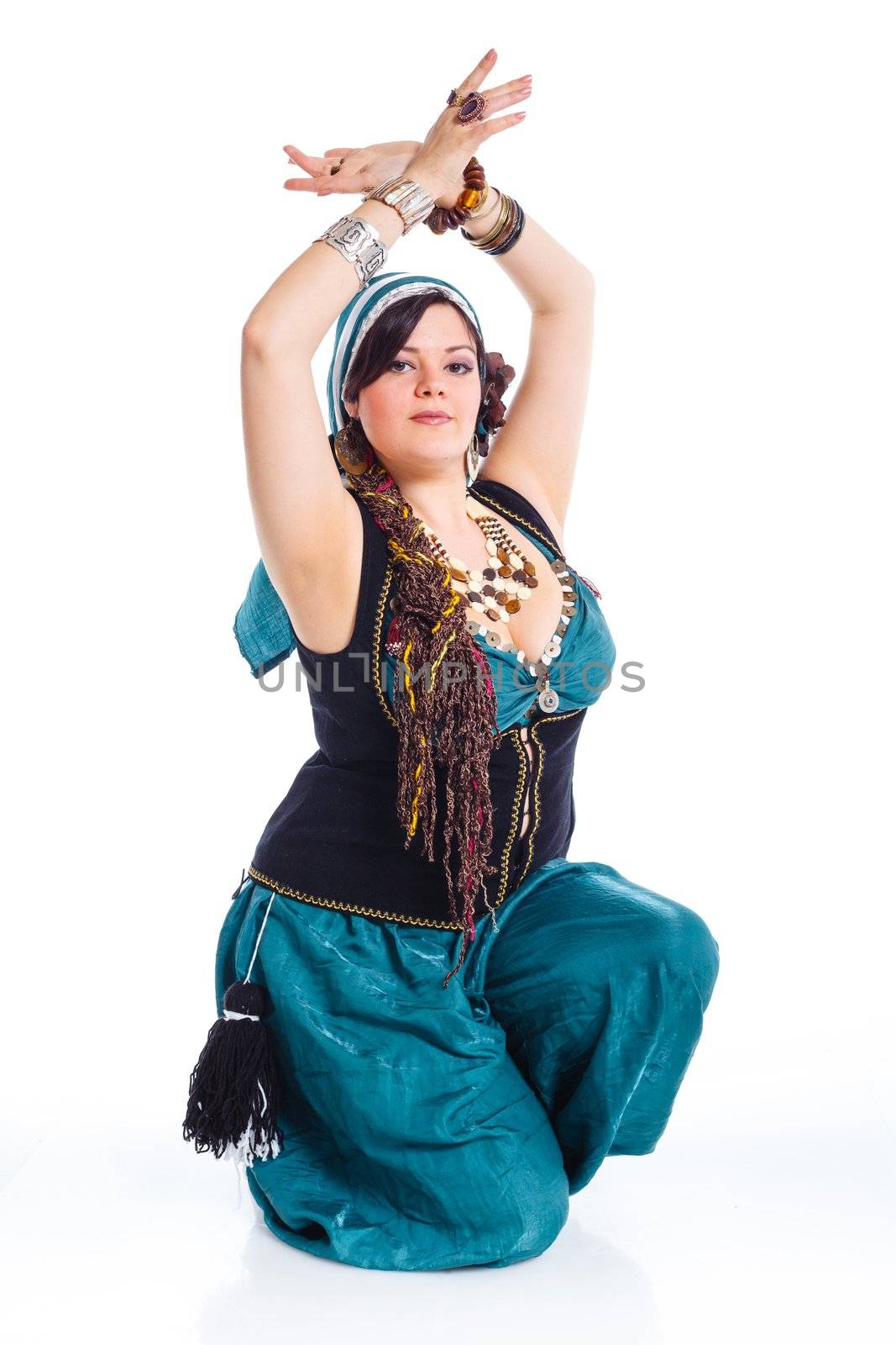 Oriental dancer in blue costume over white background