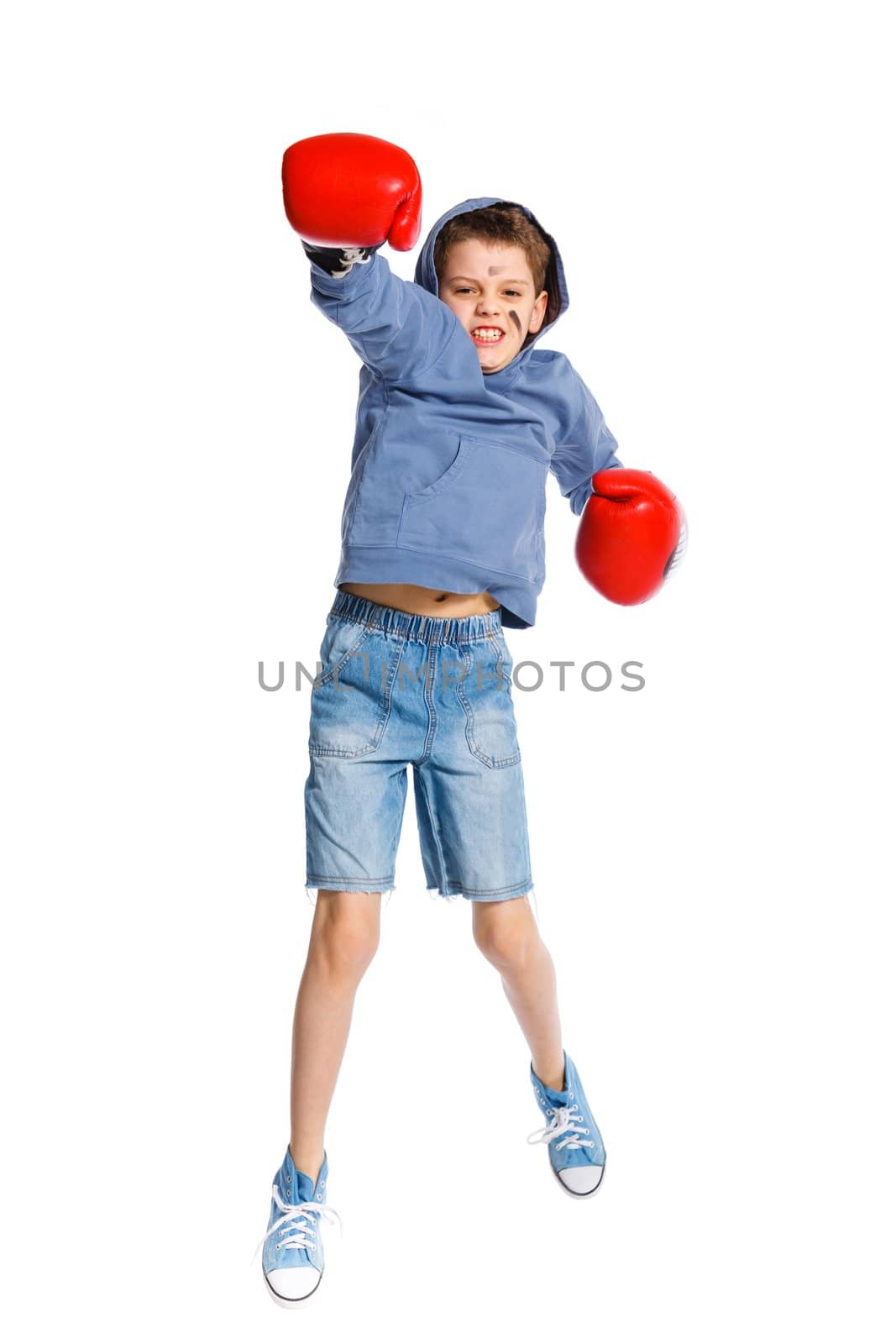 Emotional winner boxer - boy boxing wearing boxing gloves. Isolated on white background.