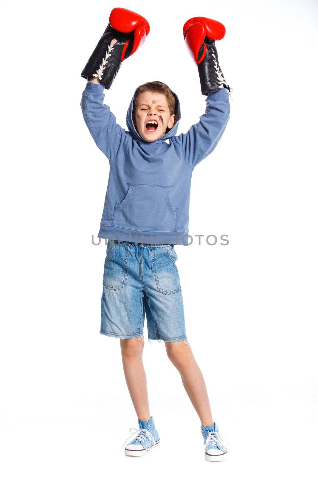 Emotional winner boxer - boy boxing wearing boxing gloves. Isolated on white background.