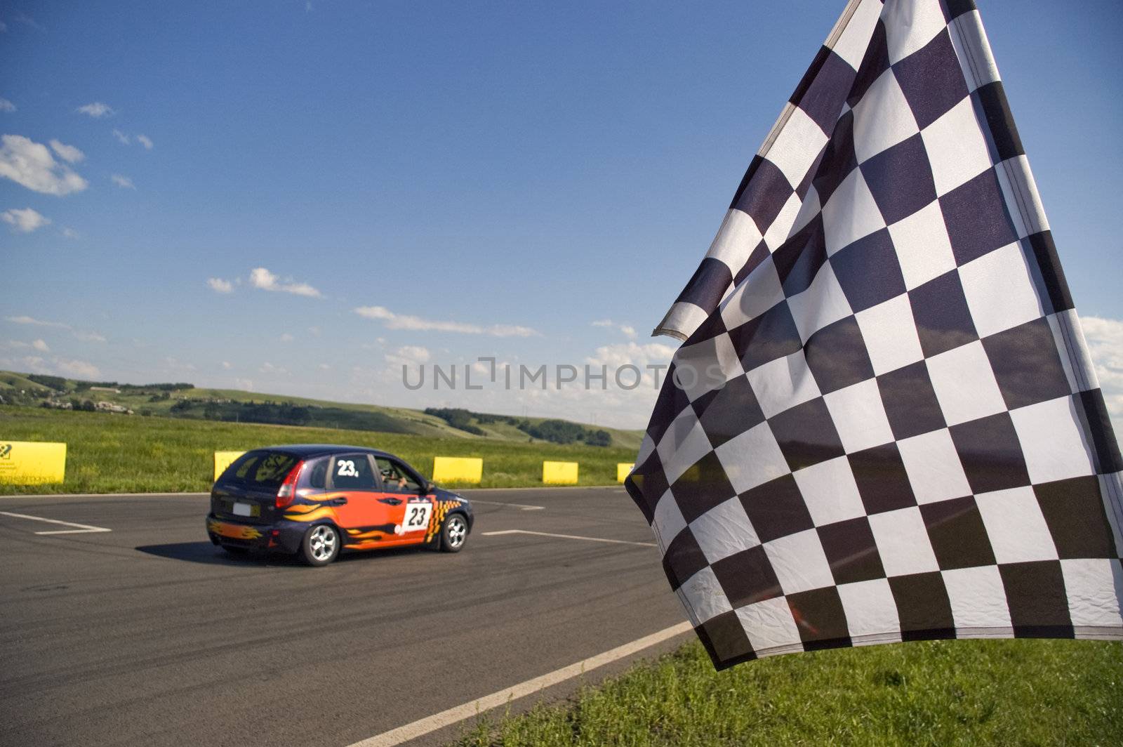 Auto racing checkered flag on a background of the  blue sky.