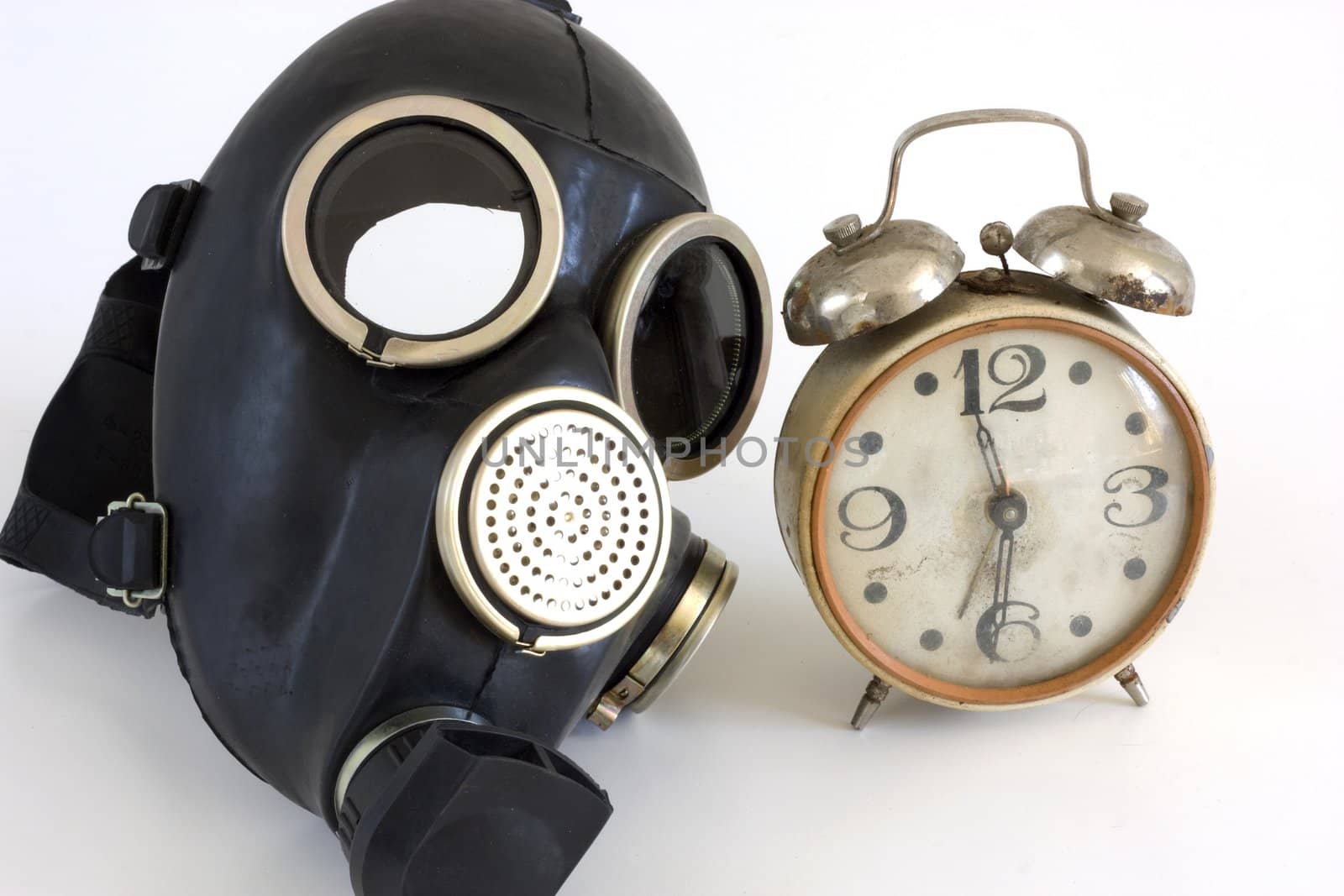 The Gas mask and old watch on white background.