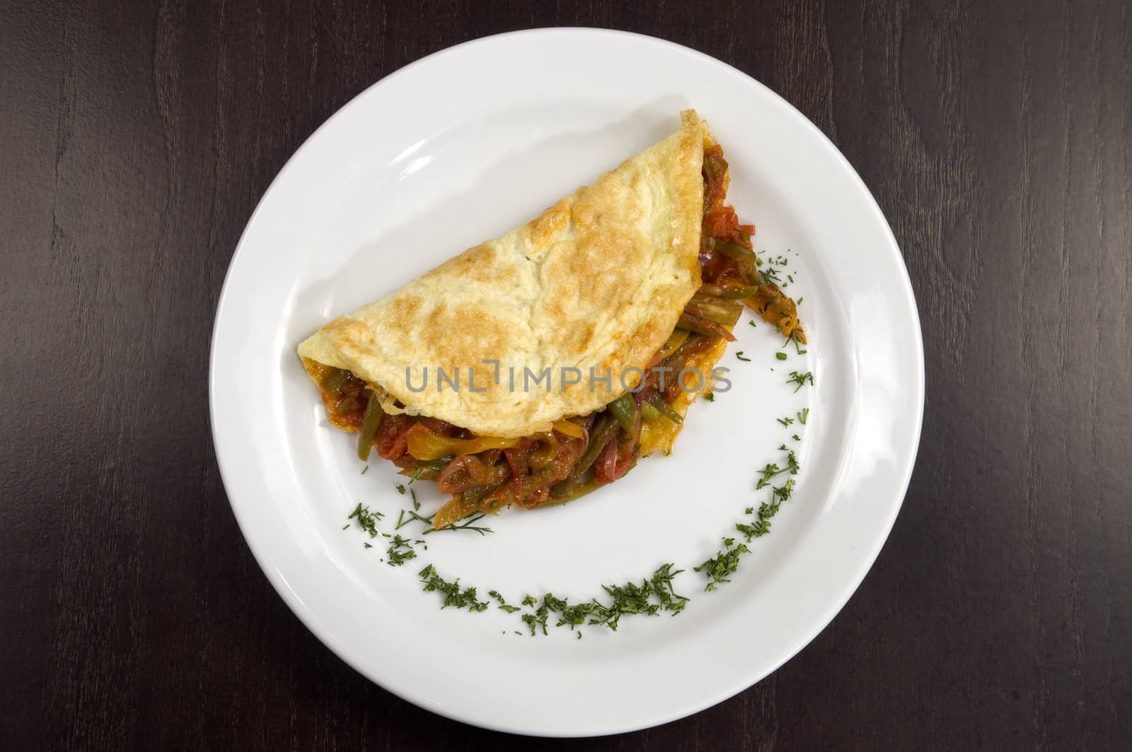 Pancakes with vegetables on a white plate.