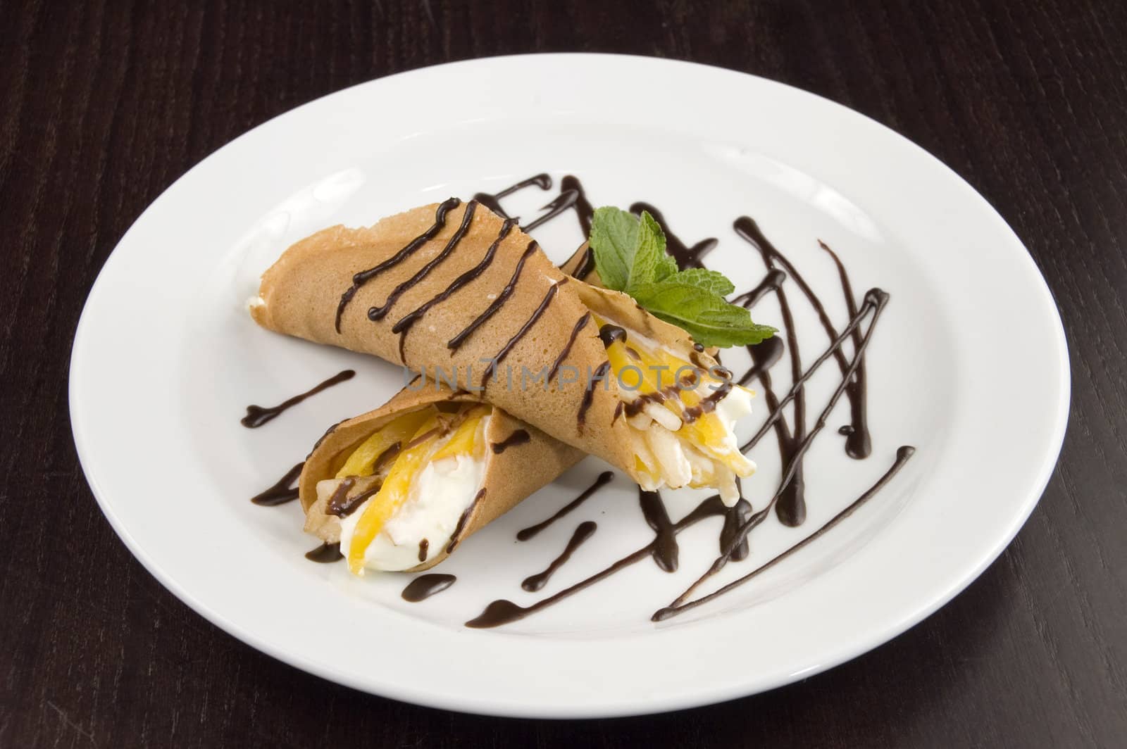 Pancakes with fruit, whipped cream in chocolate.