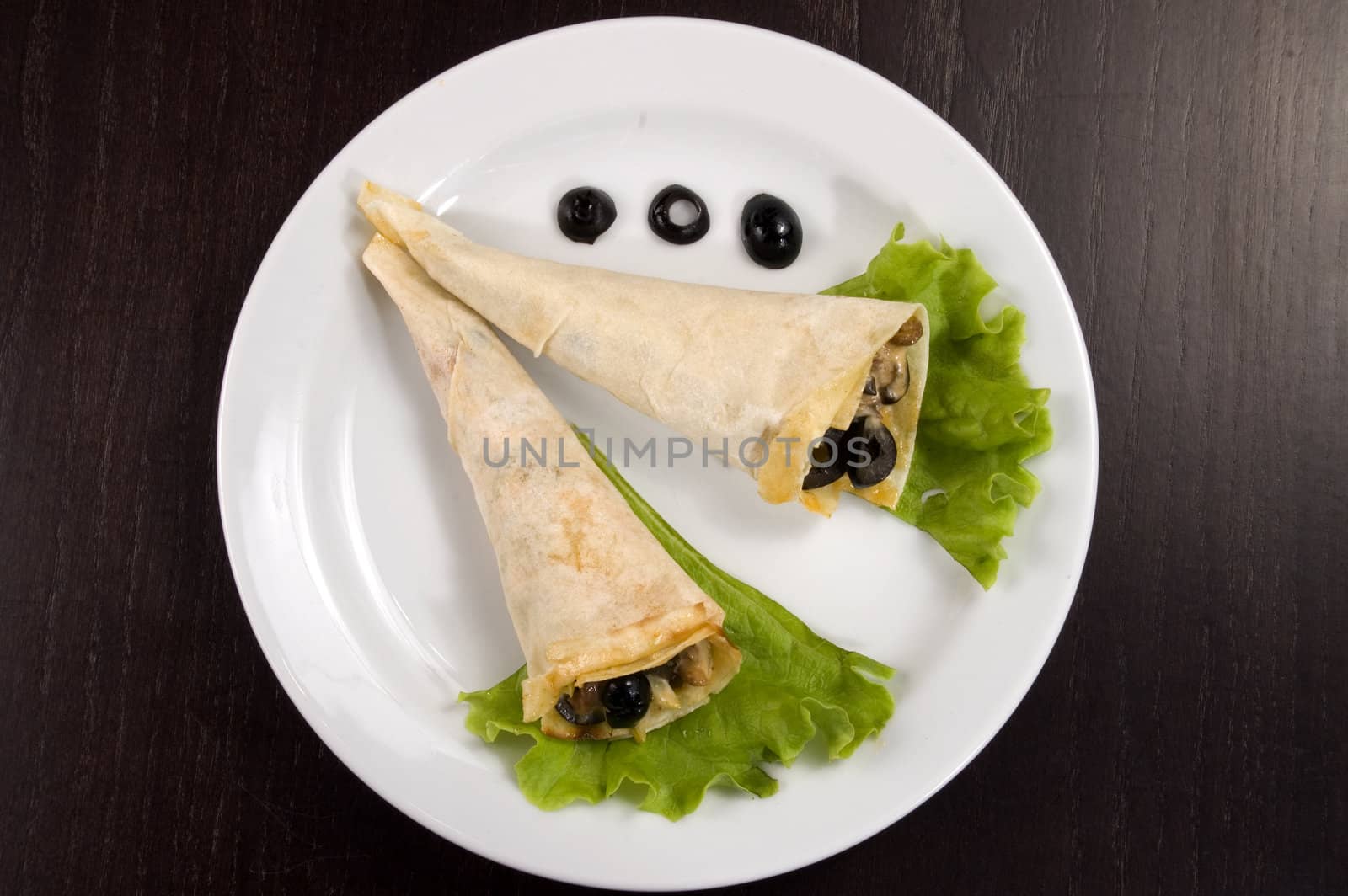 Pancakes with mushrooms, olives and green salad.