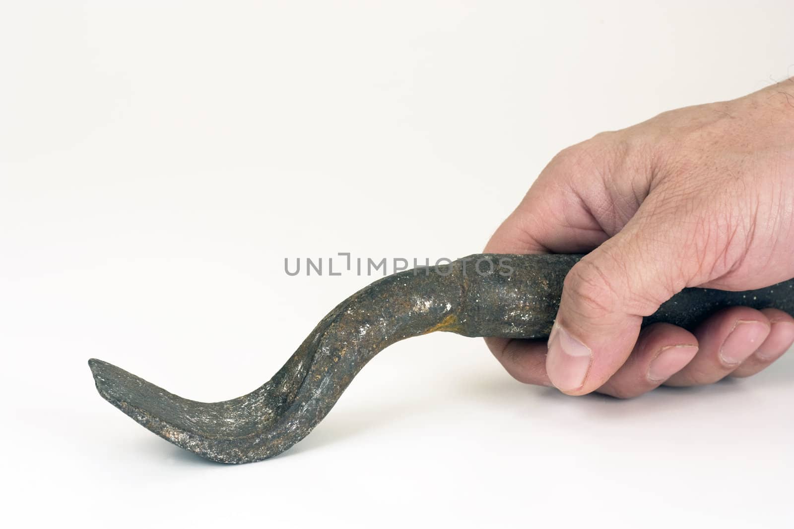 The iron tool in a hand on a white background.