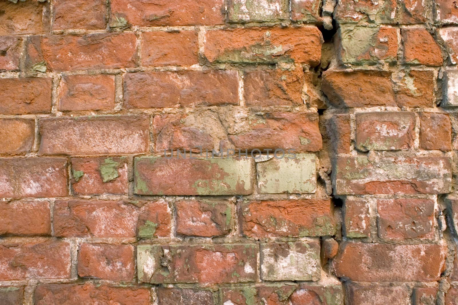 The damaged brick wall.