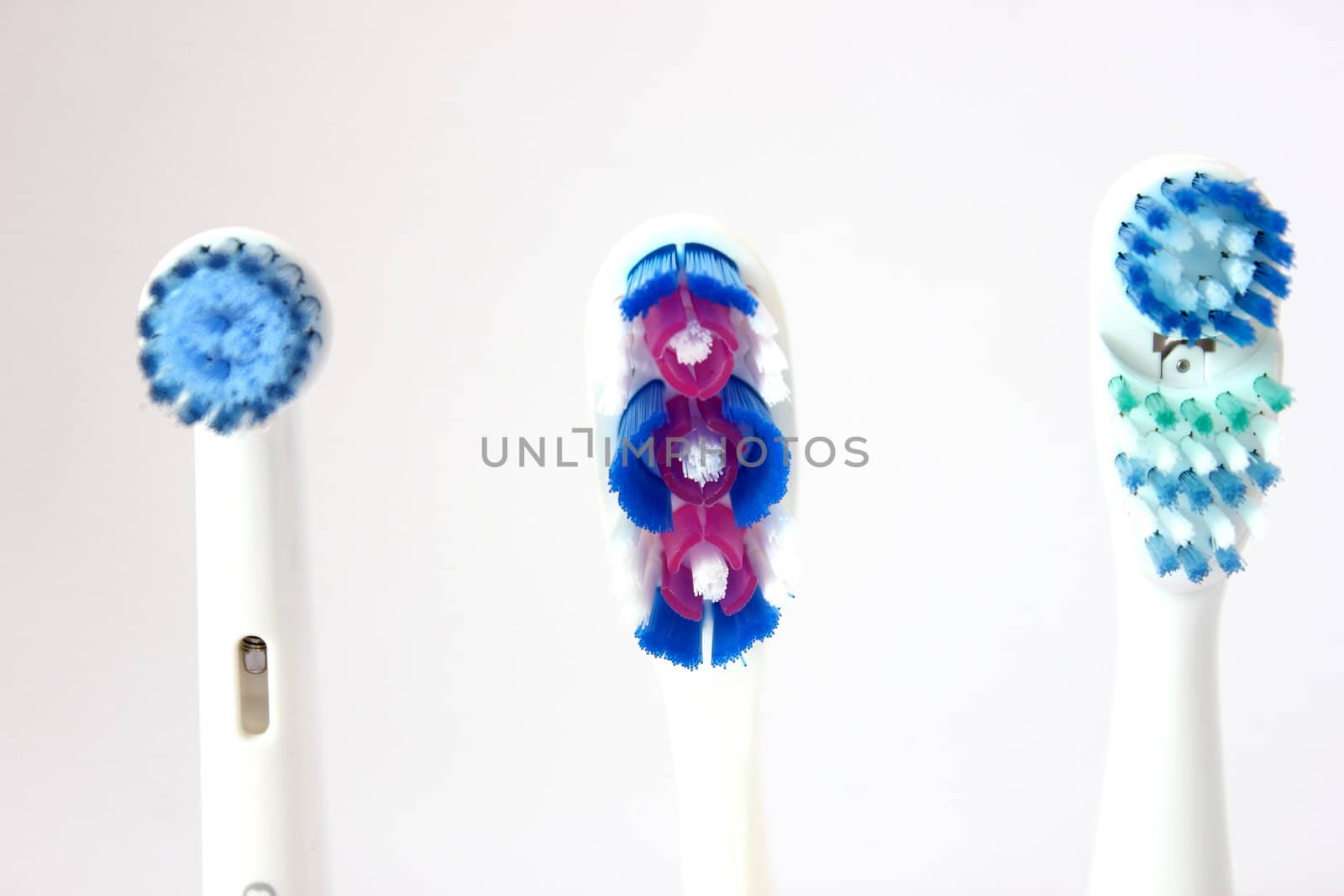 3 different types of tooth brush heads on an isolated background.