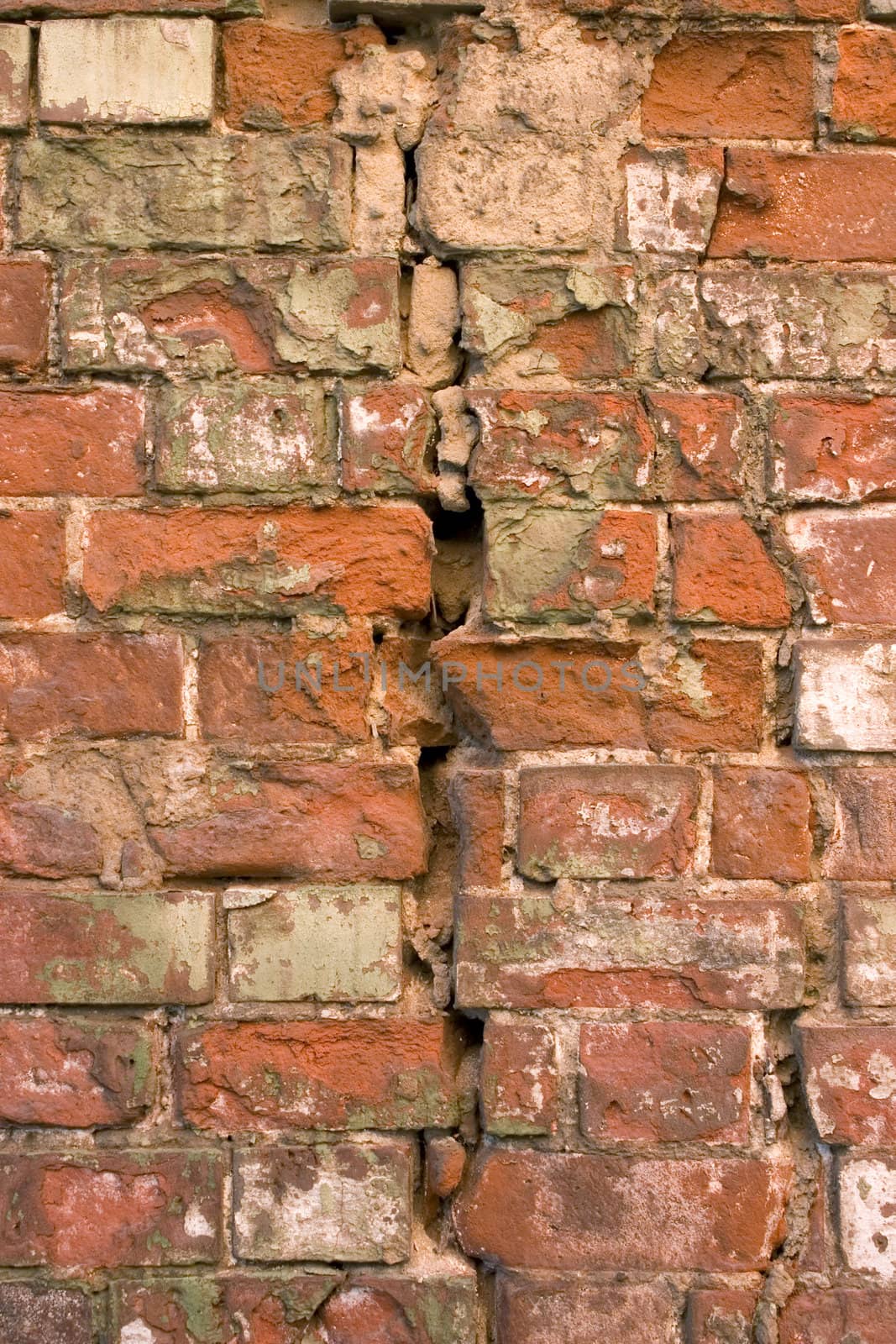The damaged brick wall.