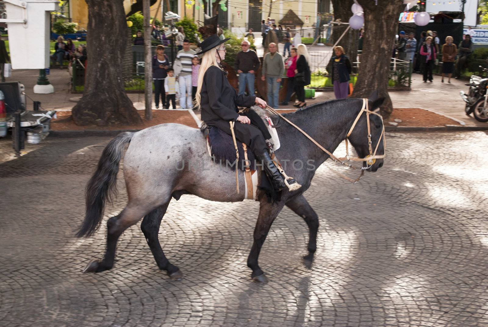 Argentina - Buenos Aires - 15 of May of 2012: woman to horse during the celebration of san isidro farmer in the province of Buenos Aires