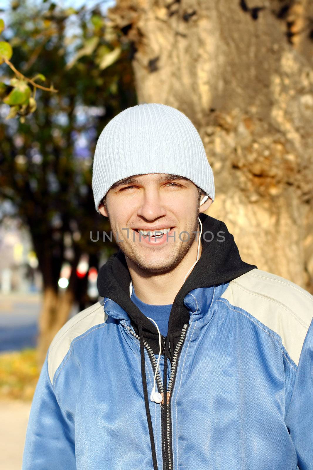 cheerful man stand on the street in the autumn clothes