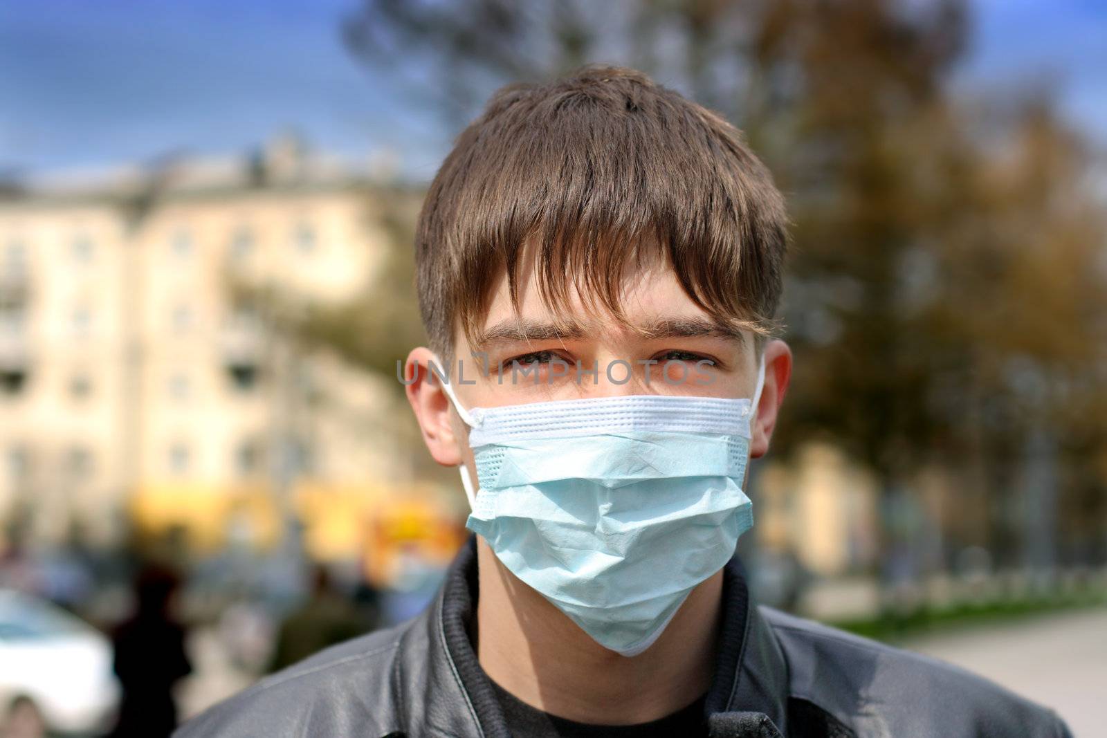 teenager in the flu mask on the street