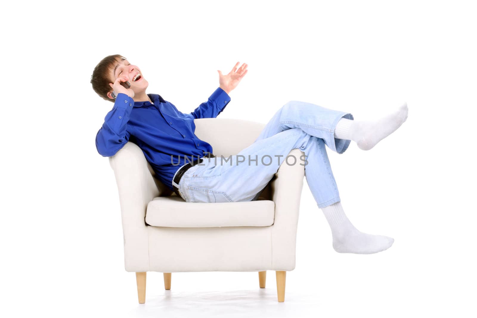 happy teenager with mobile phone in a chair. isolated on the white background