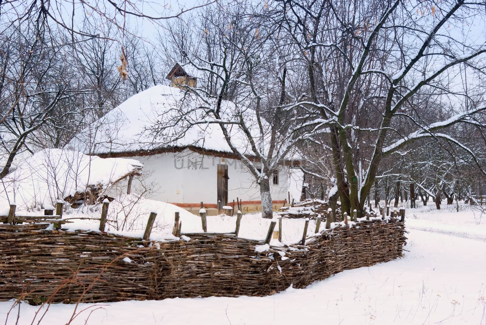 wicker fence against the backdrop of an old house