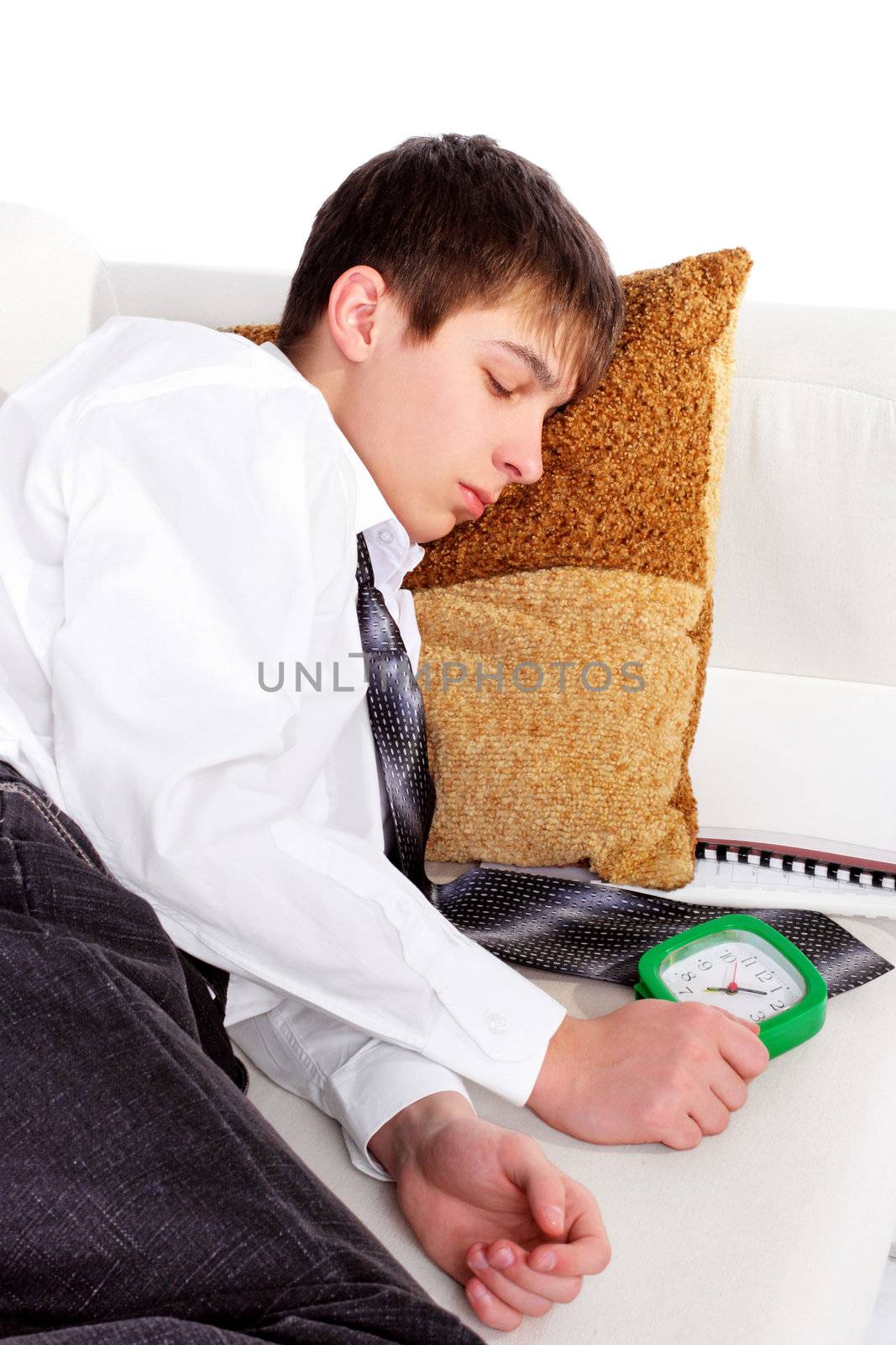 Student sleeping on the Sofa with the Books and Alarm Clock