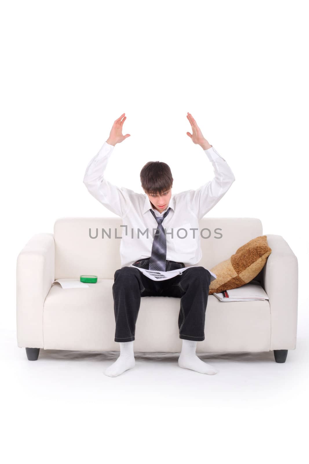 Shocked Teenager reads the book on the Sofa. Isolated on the white