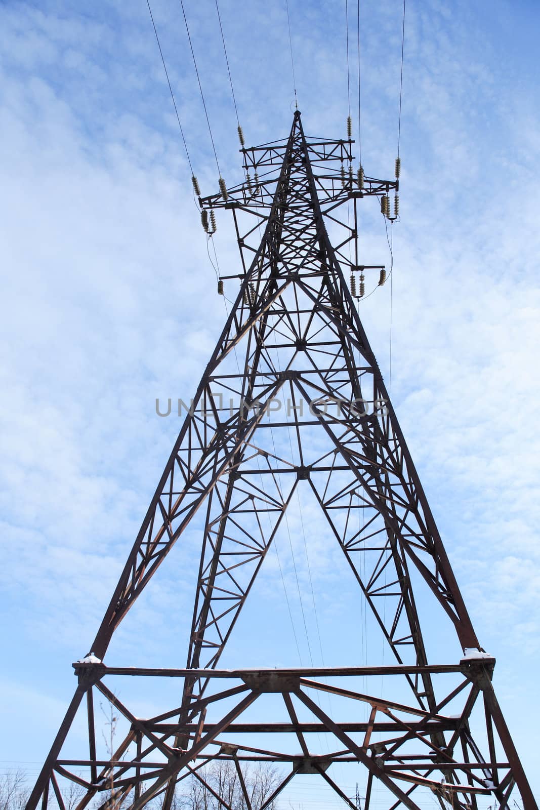 High voltage tower against blue sky
