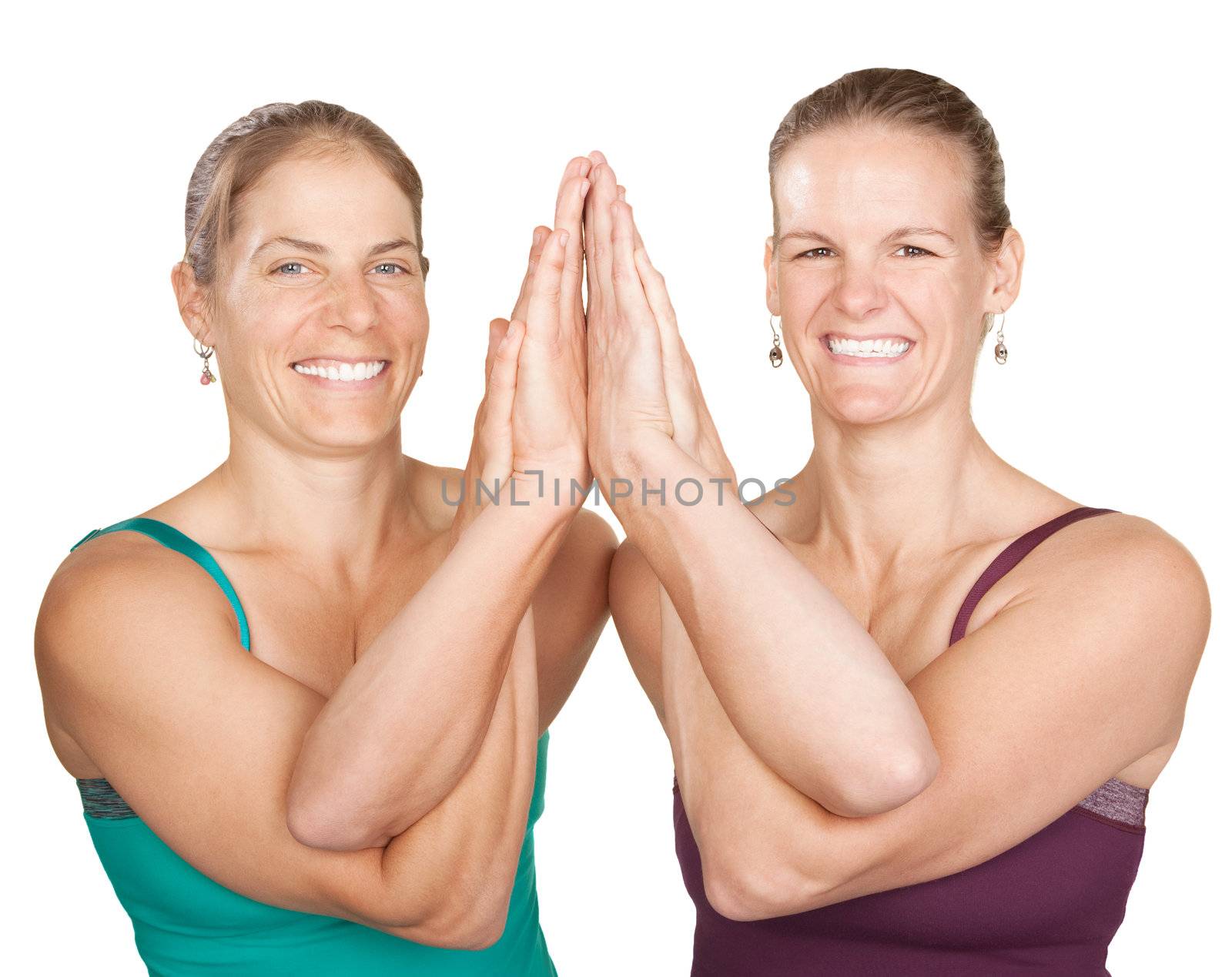 Two smiling women perform entwined namaskar over white background