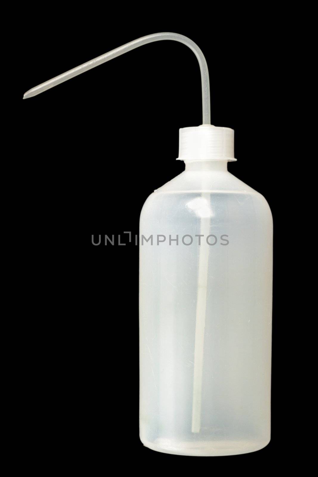 big plastic dropper isolated over dark background