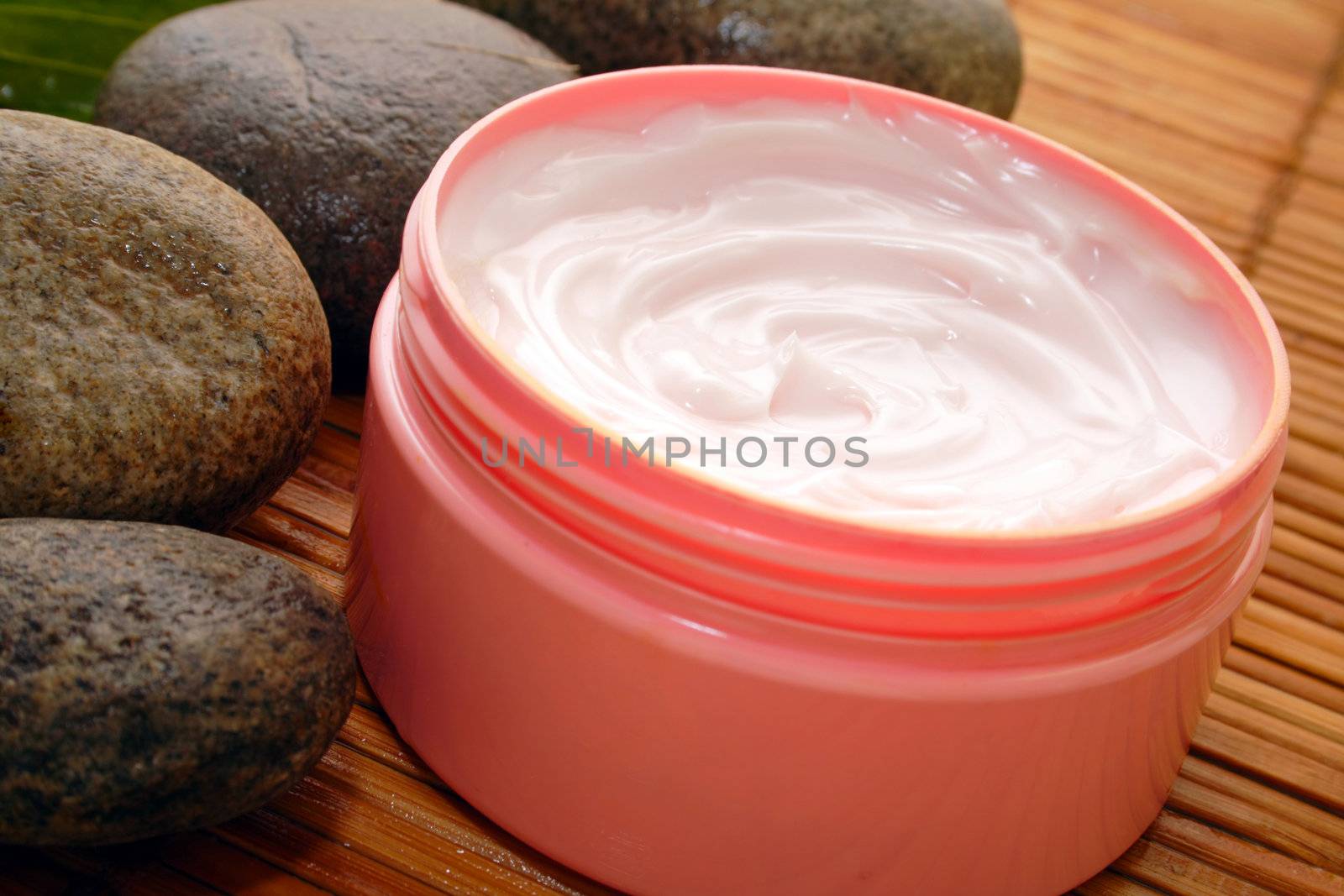 cosmetic cream against a background of bamboo