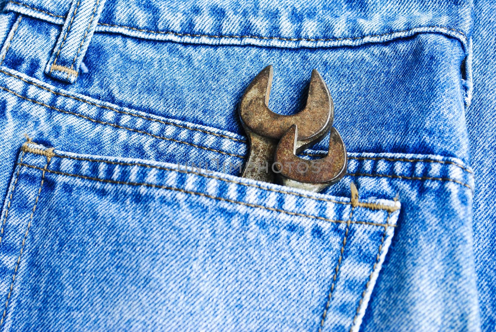 Wrench set in the pocket of grey jeans,focus on