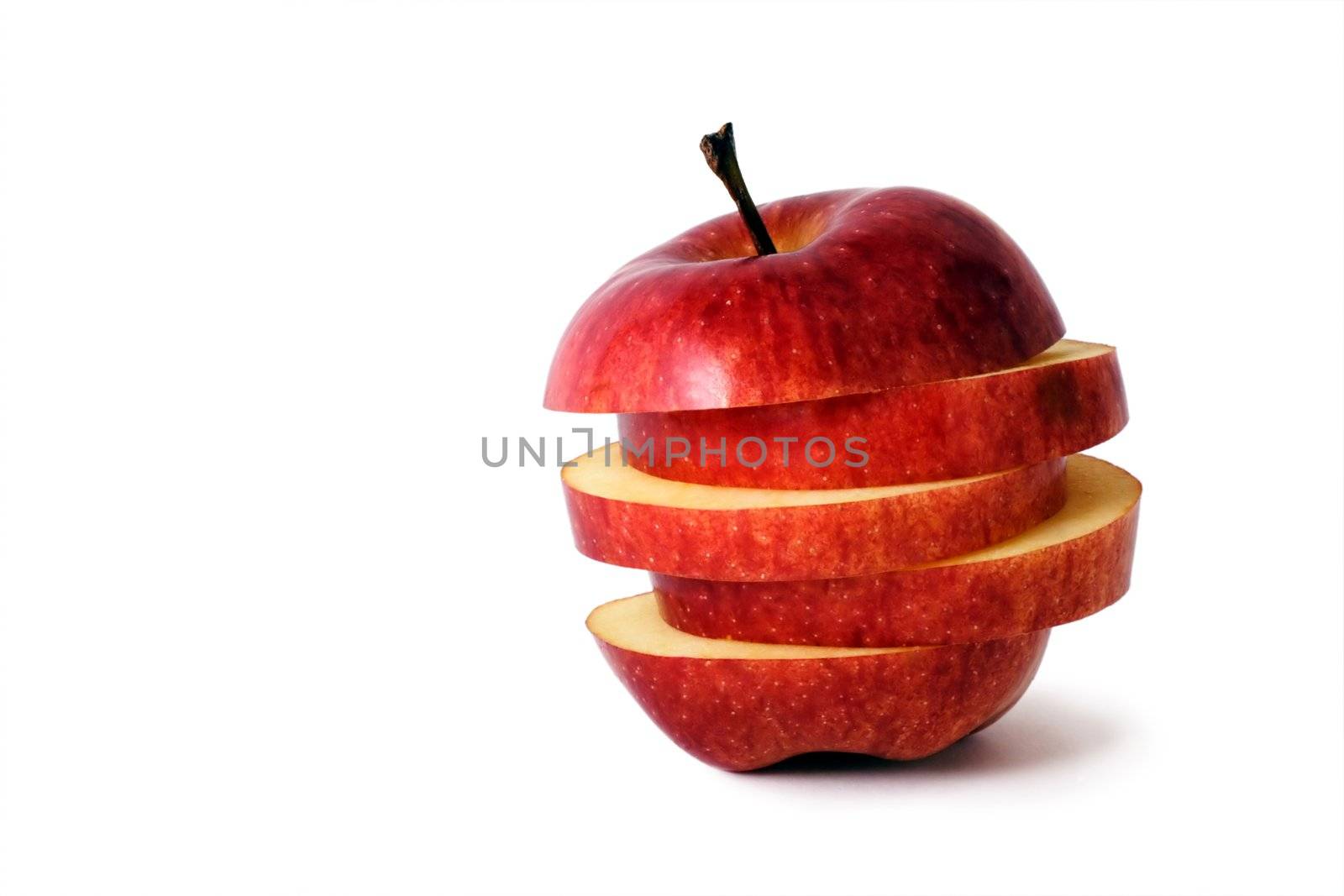 slices of an apple put together to form a hybrid fruit, shot on white in a studio