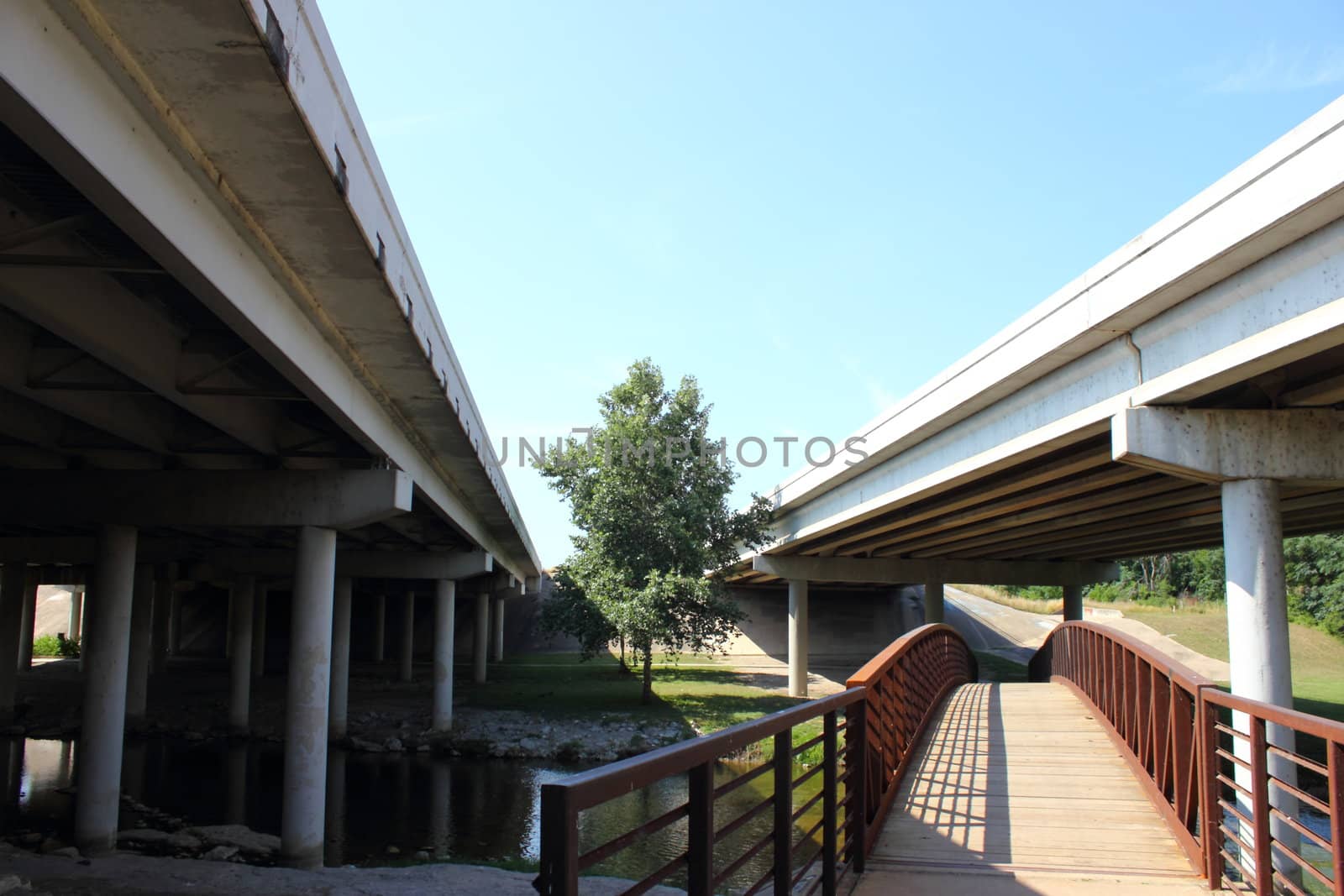 Two highway bridges with old antique bridge underneath.