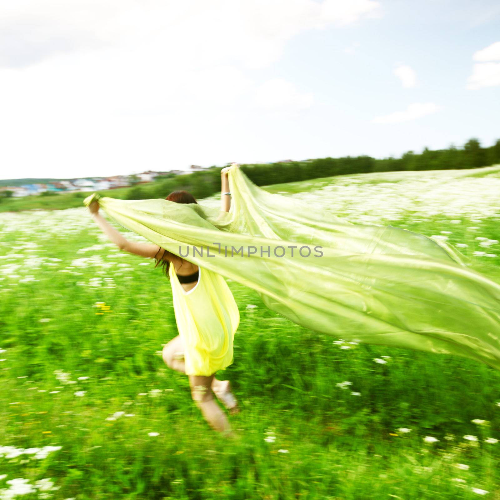  girl run by field fabric in hands fly behind like wings