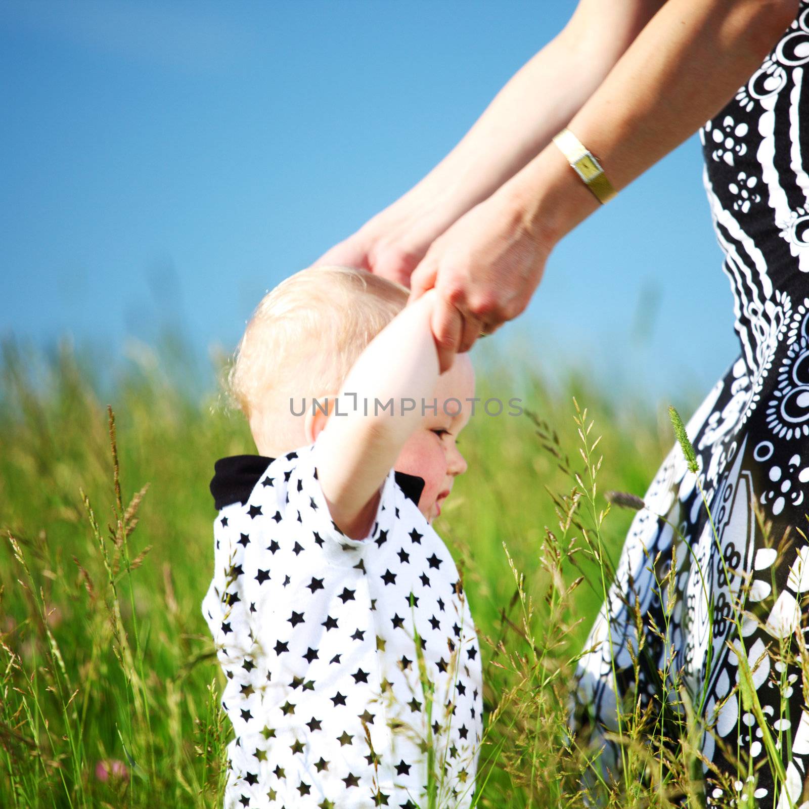 mother and take son by hands in field