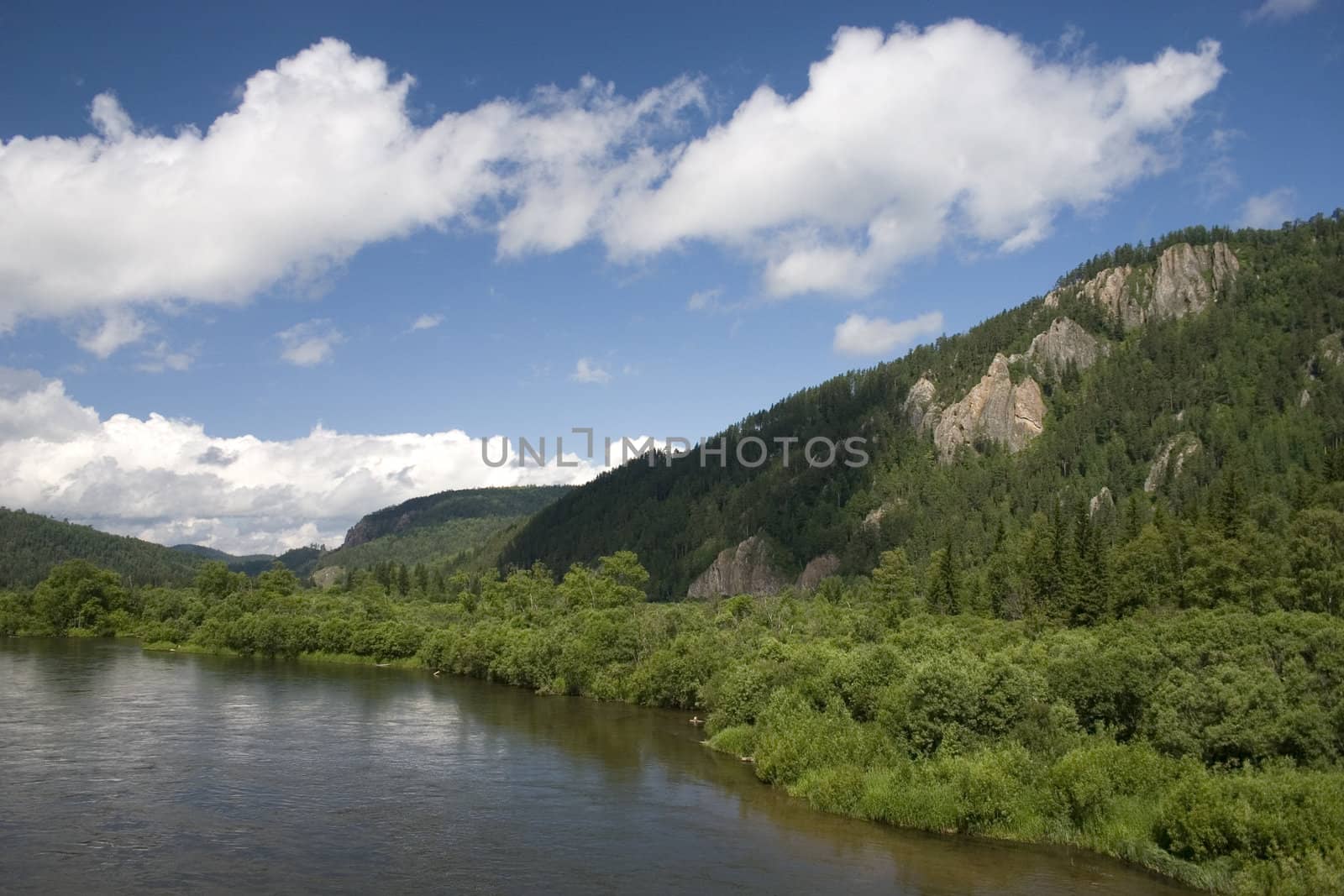 Summer. A river landscape with clouds.