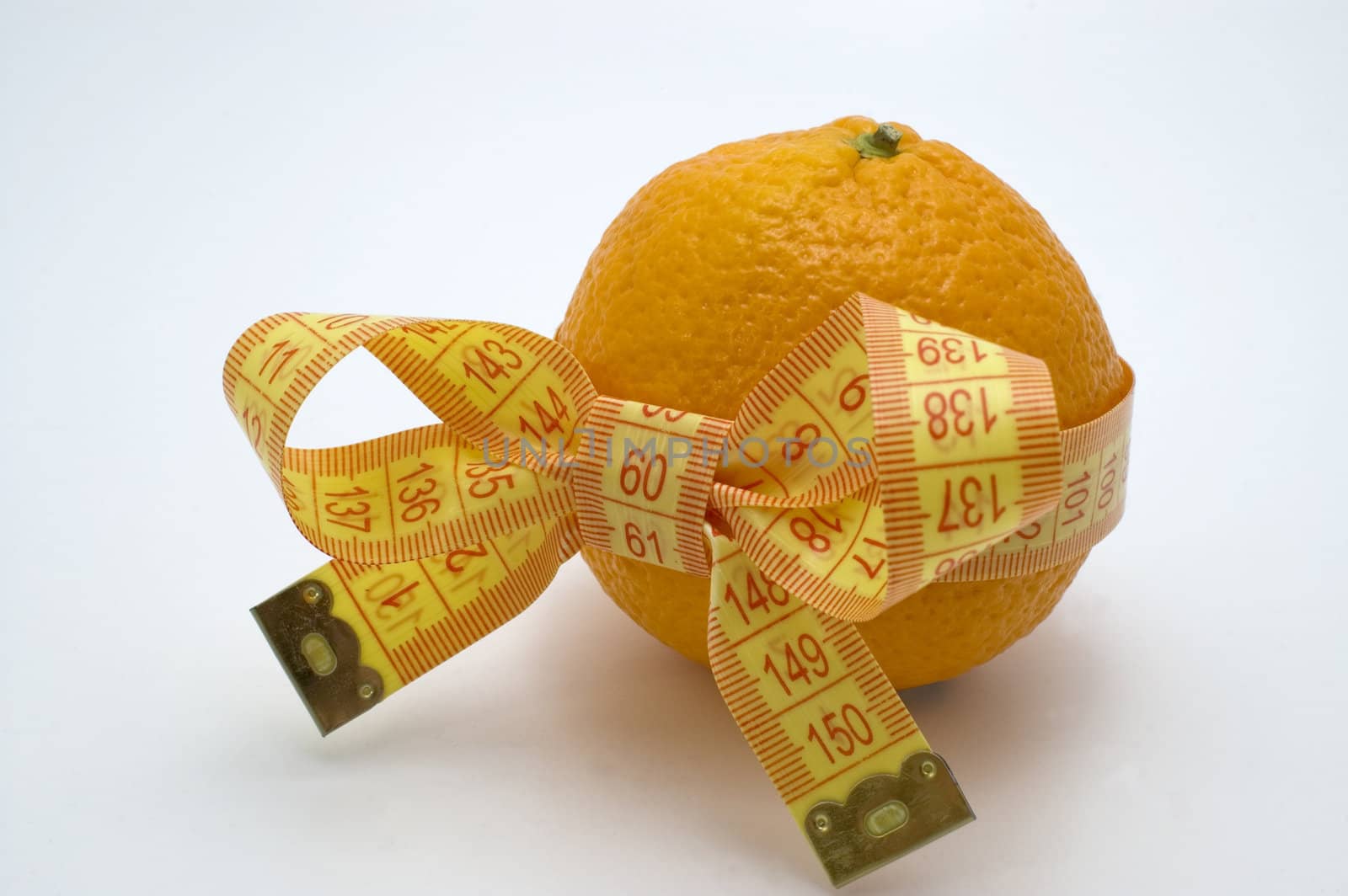 Orange  with measuring tape. White background.