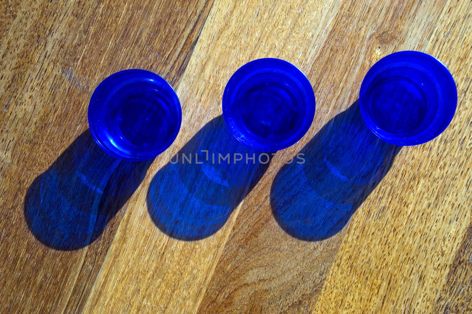 Dark blue utensils, shadow on a floor.