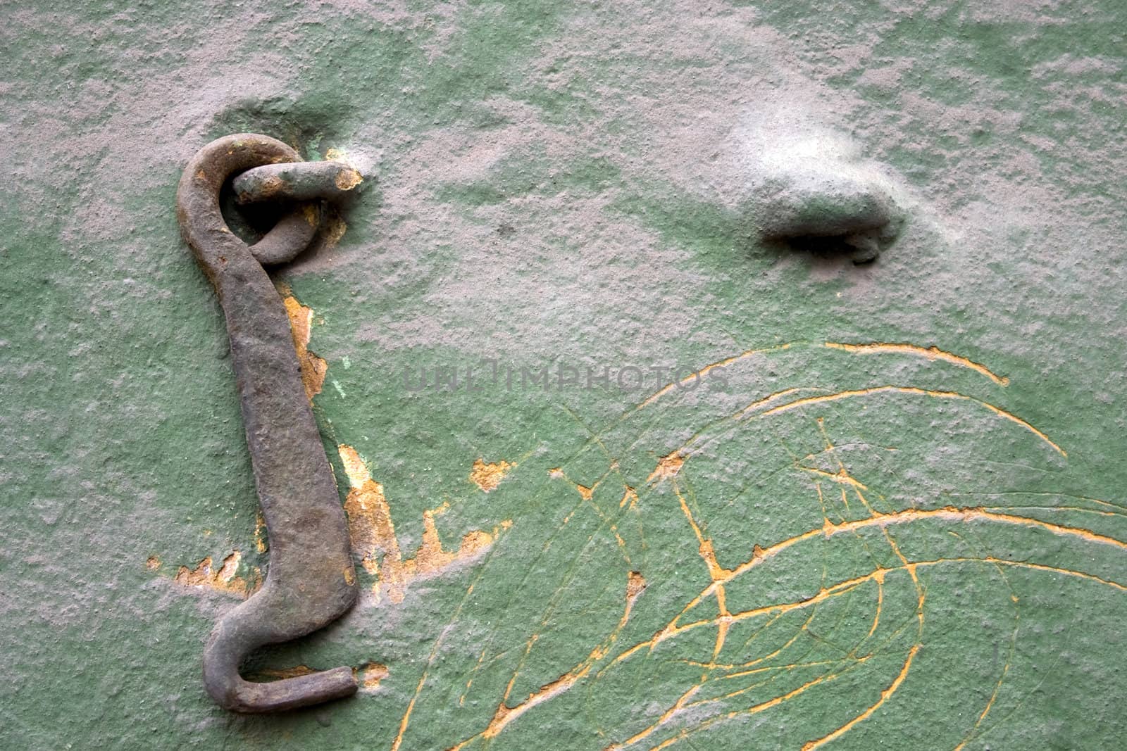 Old wall with a metal hook.