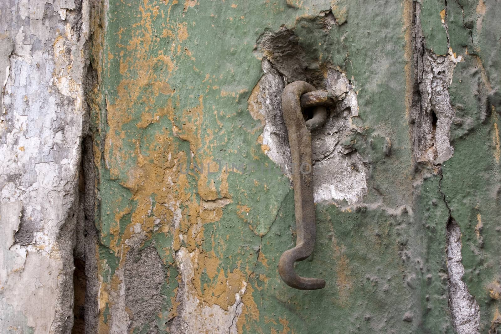 Old wall with a metal hook.