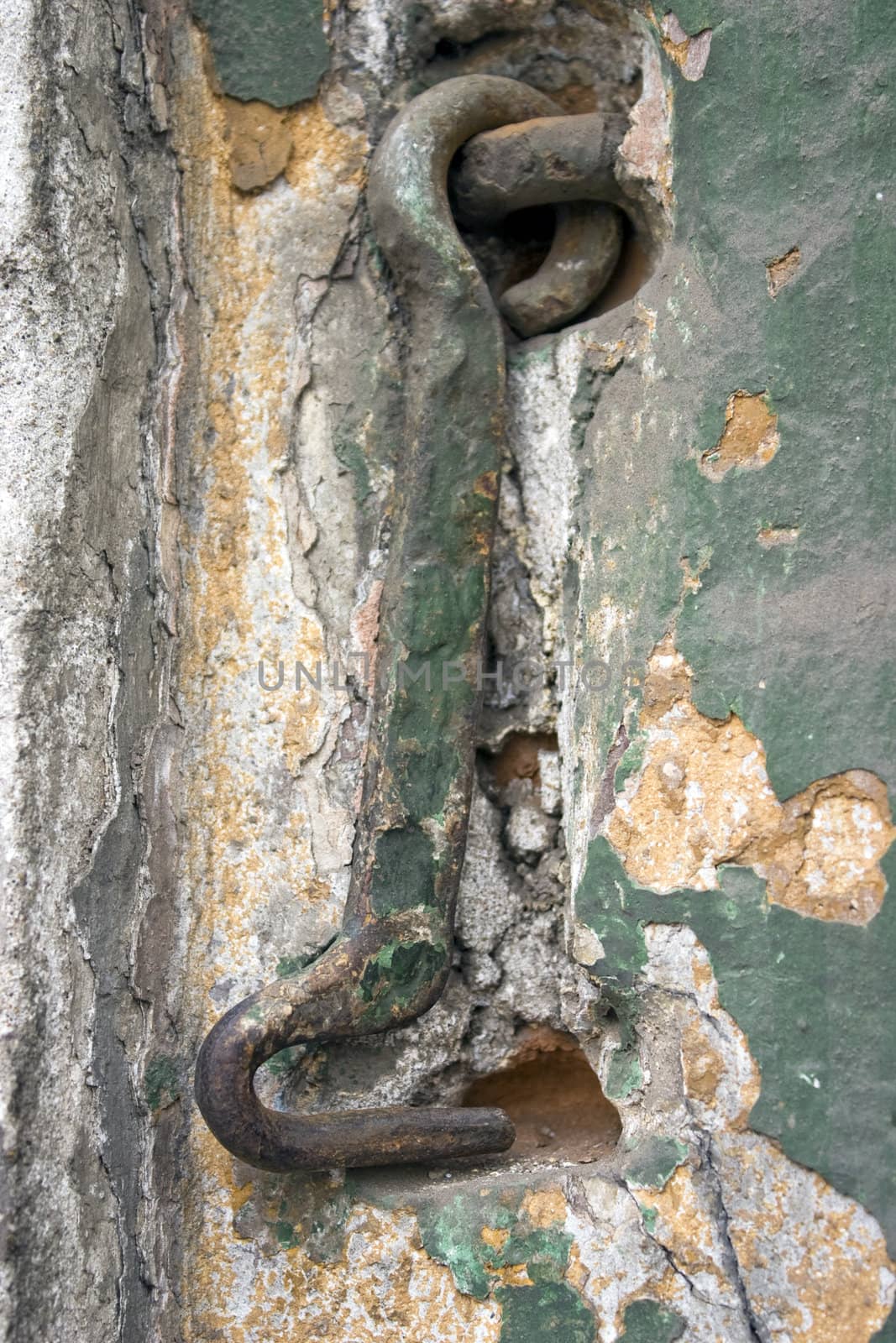 Old wall with a metal hook.