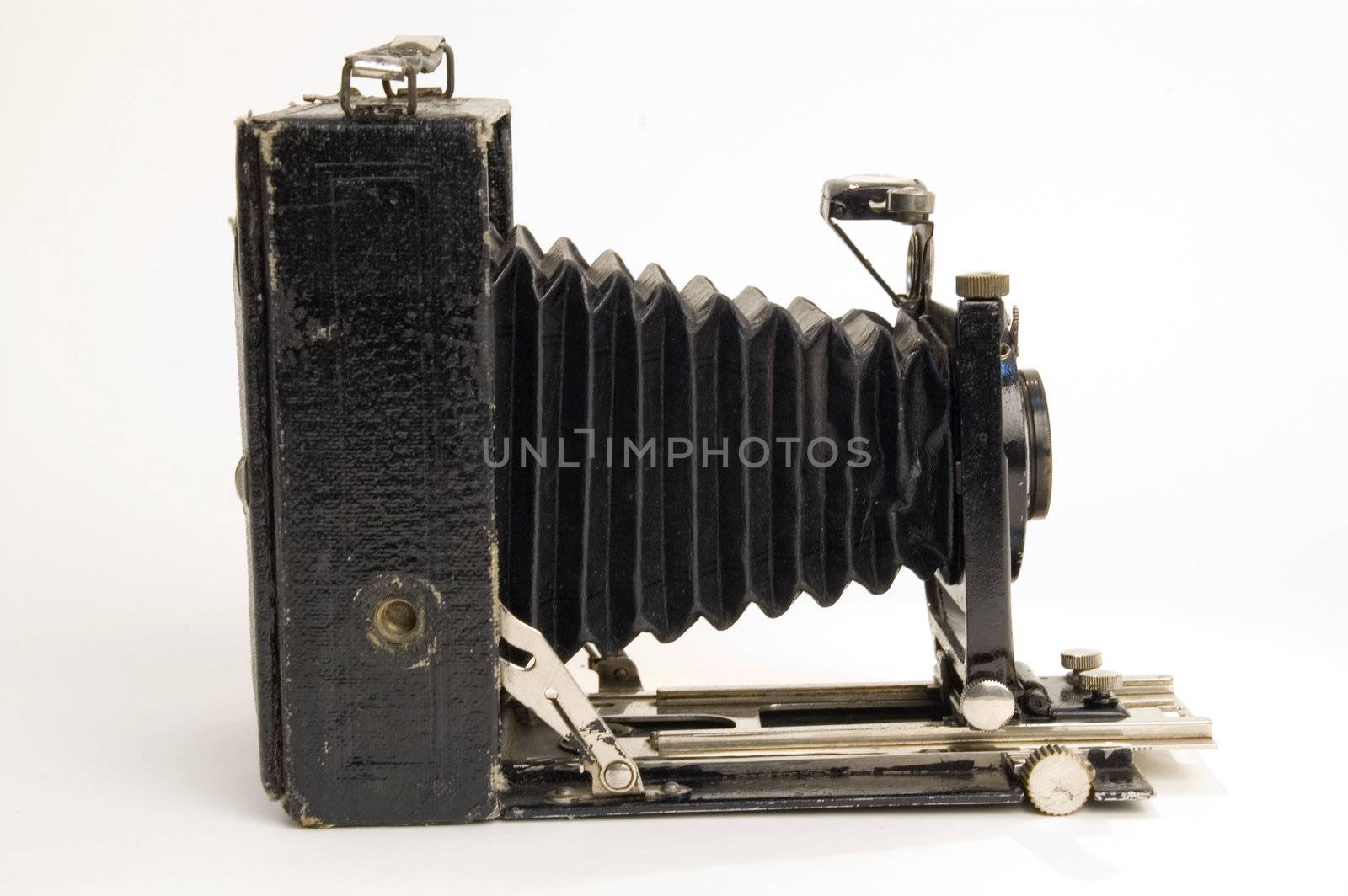 The old photographic chamber with a lens of furs on a white background.
