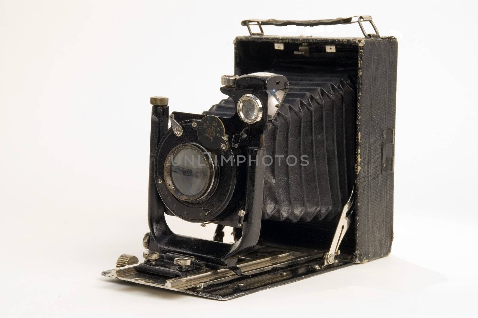 The old photographic chamber with a lens of furs on a white background.